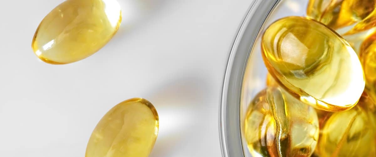 Fish oil capsules in a glass bowl